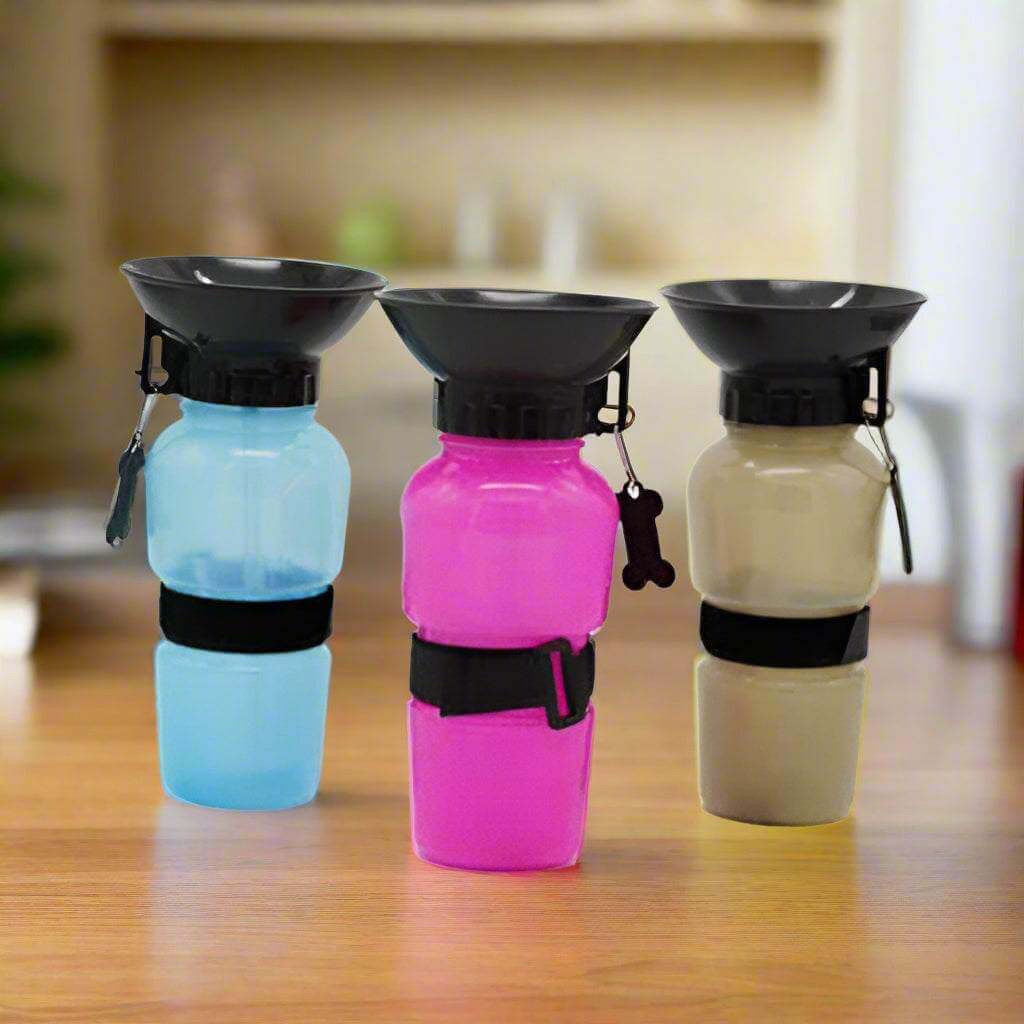 Portable dog water bottles in blue, pink, and beige colors, designed for pet hydration on the go.